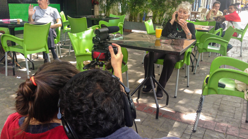 Amanda Perez and Rober Calzadilla filming Yarima Hidalgo at a cafe for A Family of Stories
